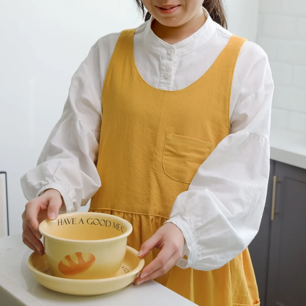 Hanee golden cotton cottagecore pinafore worn while preparing breakfast